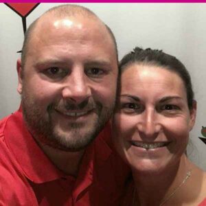 Close-up photo of a smiling man and woman posing together.